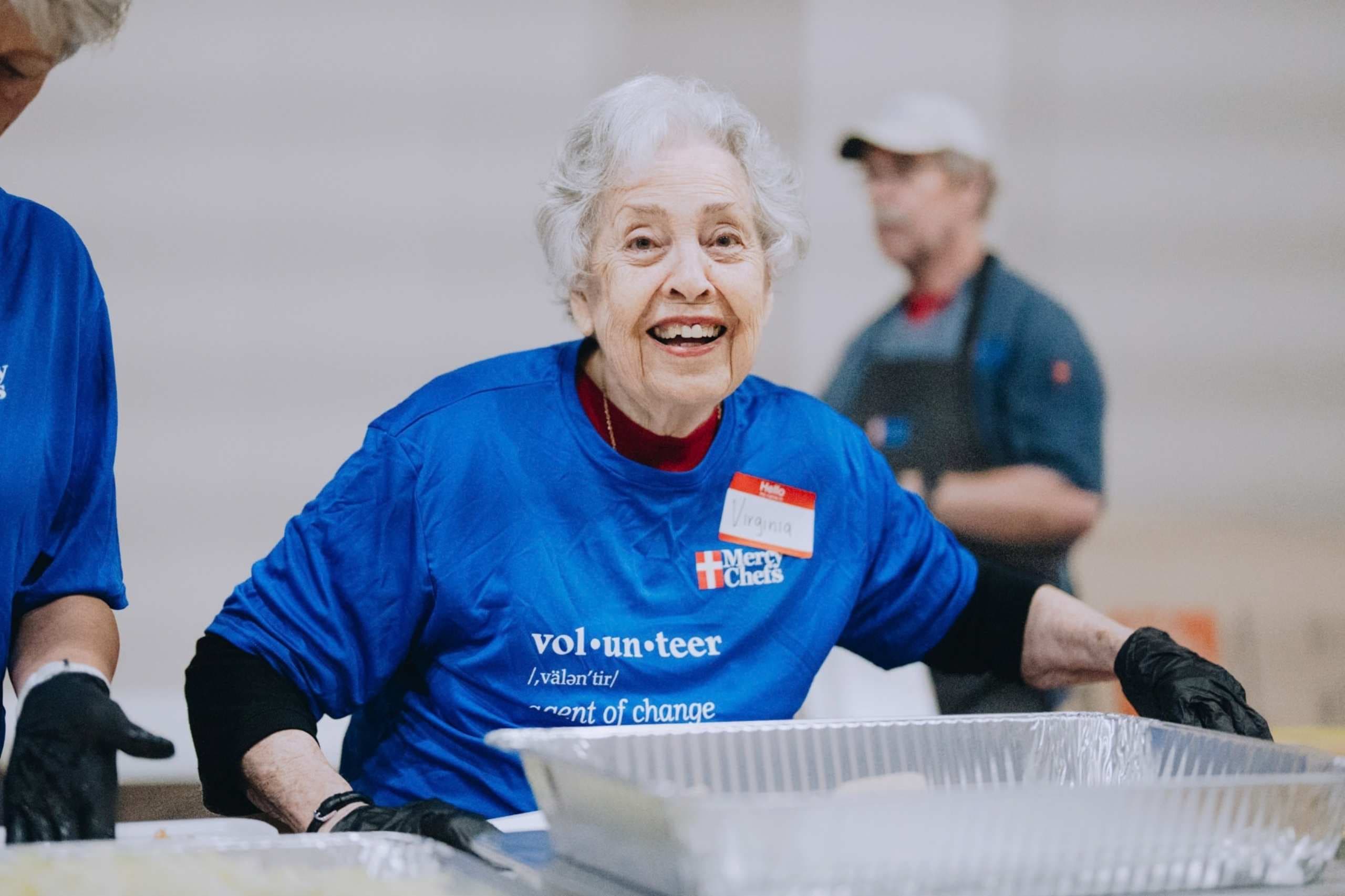 A volunteer helps plate a hot meal in St. Louis