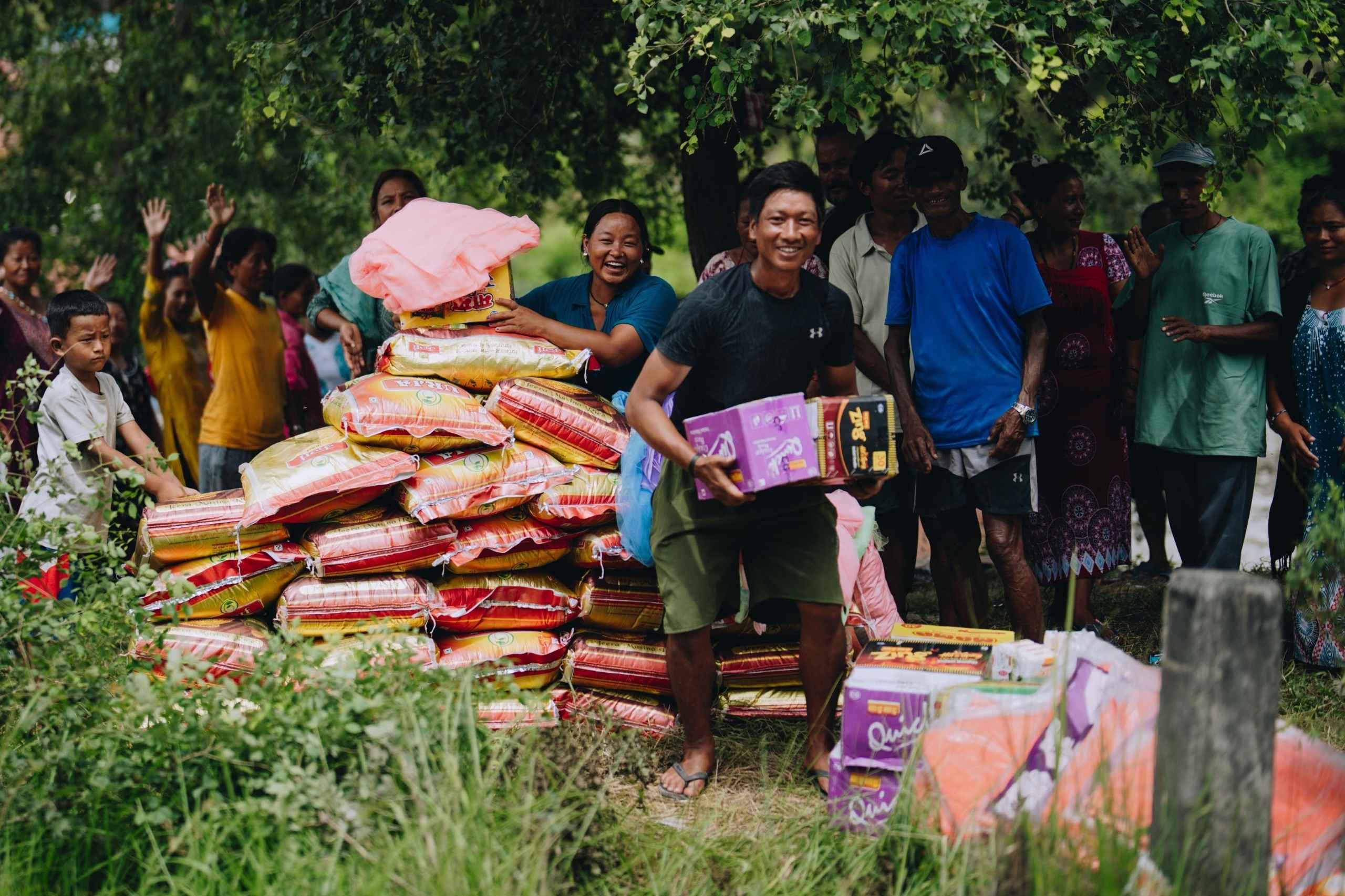 Families in Nepal receive grocery meals with a smile.