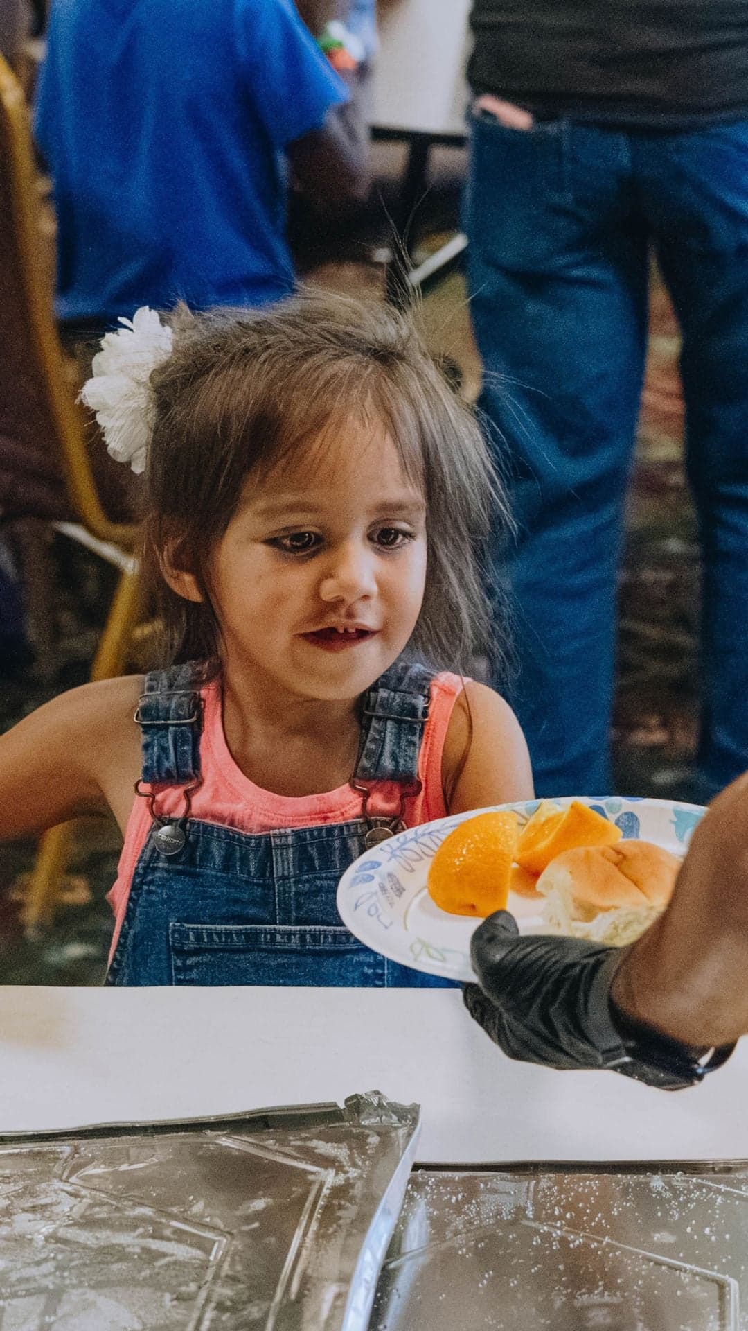 Young girl tries a strawberry during a cooking class