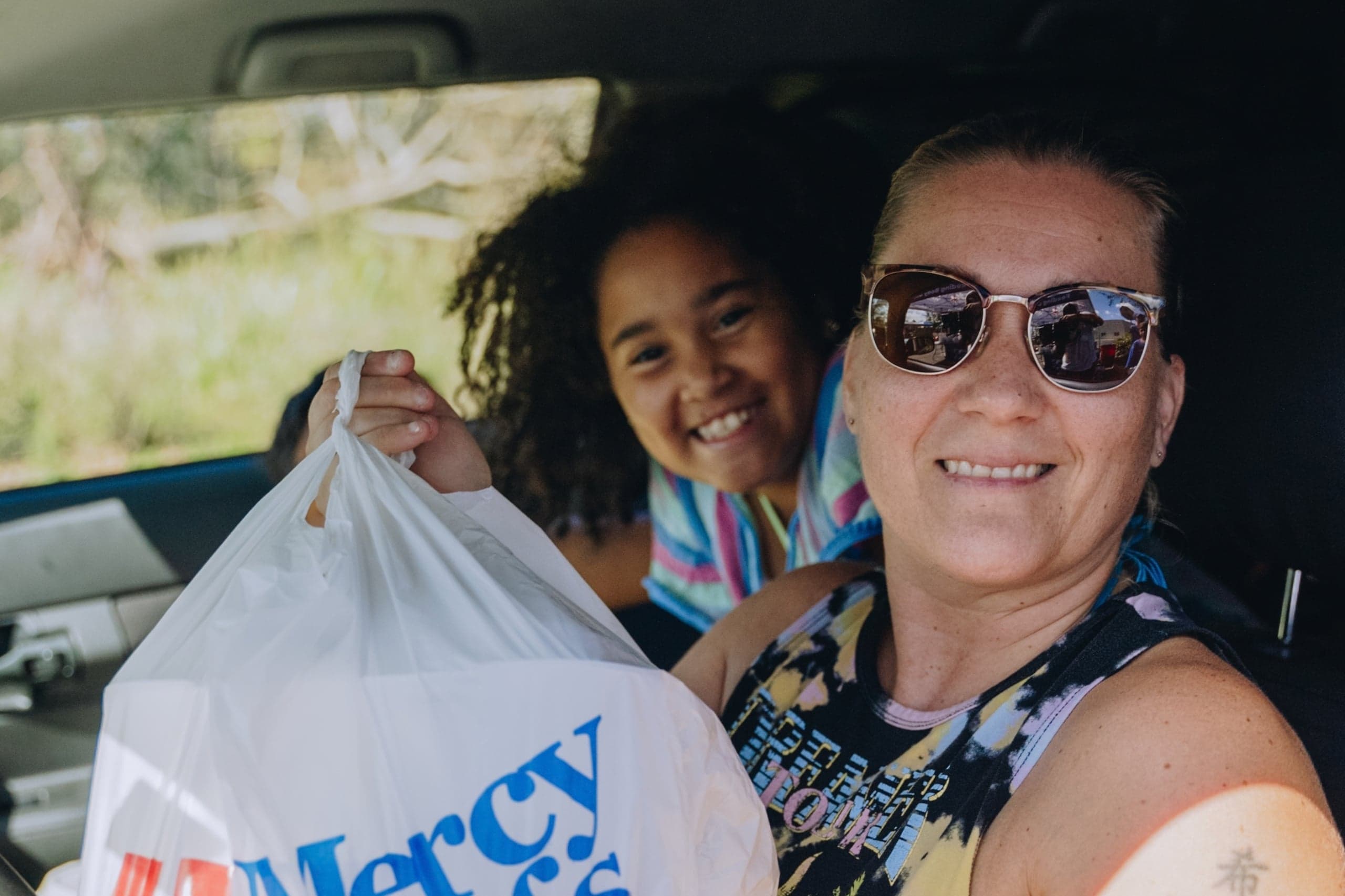 Mother and daughter receive a bag of Mercy Chefs meals